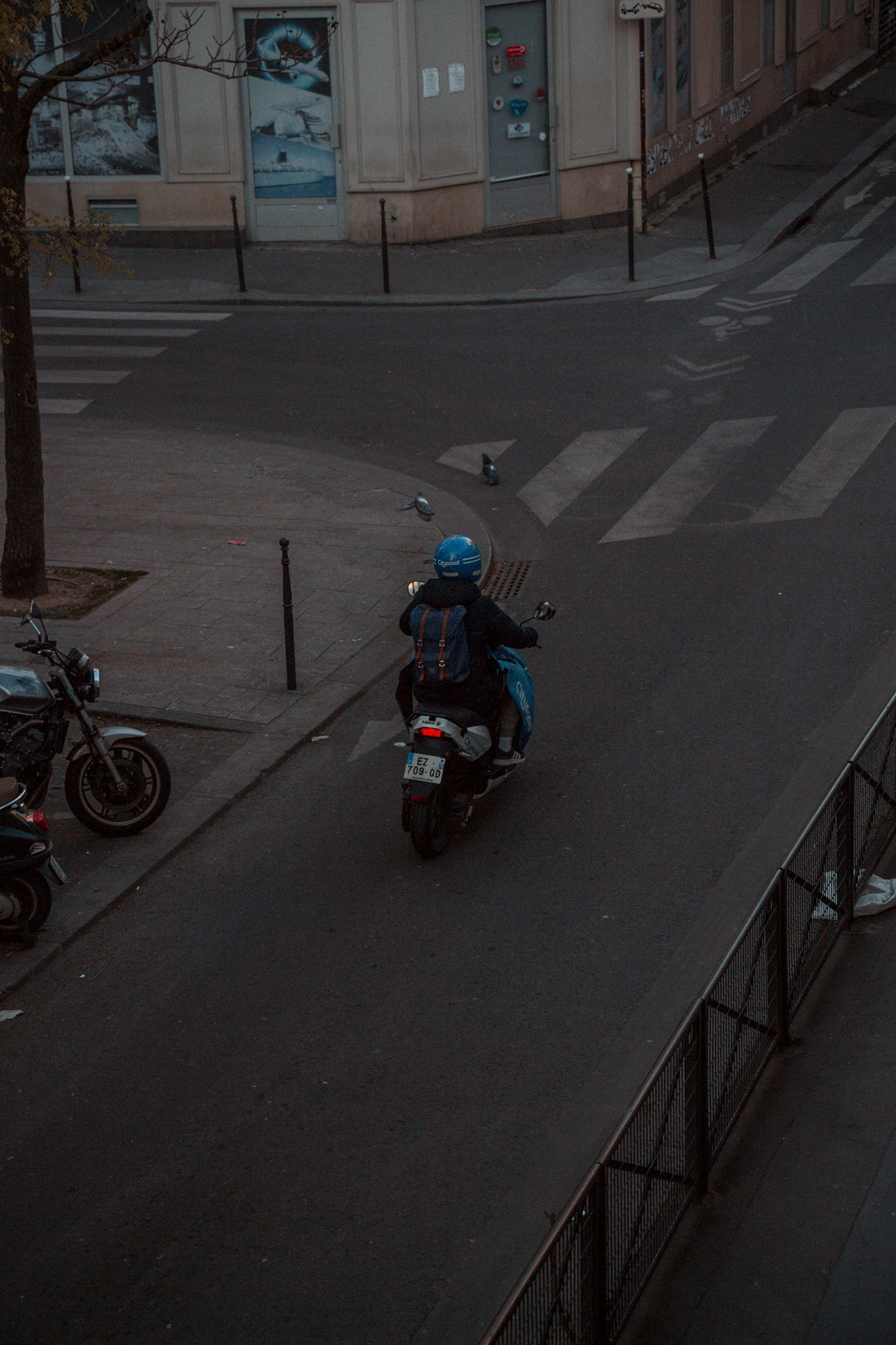 man in blue and black motorcycle on road during daytime
