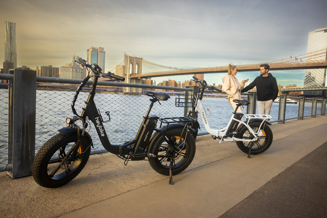 a couple of people standing next to a parked bike