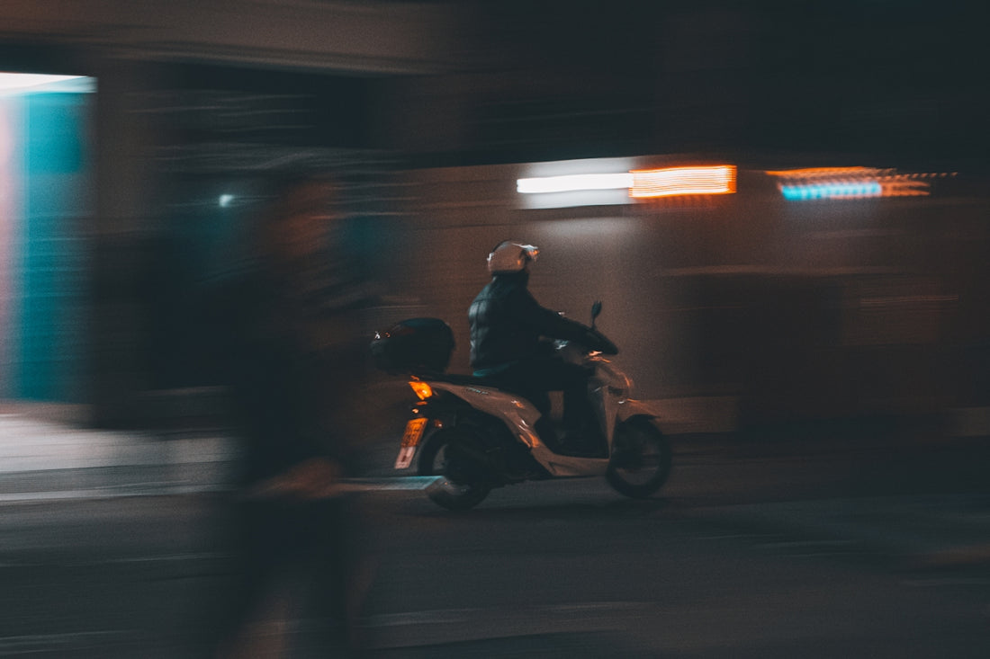 a person riding a scooter on a city street