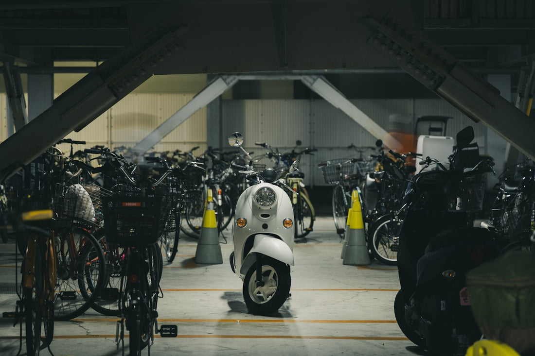 White scooter parked among bicycles underpass bicycles