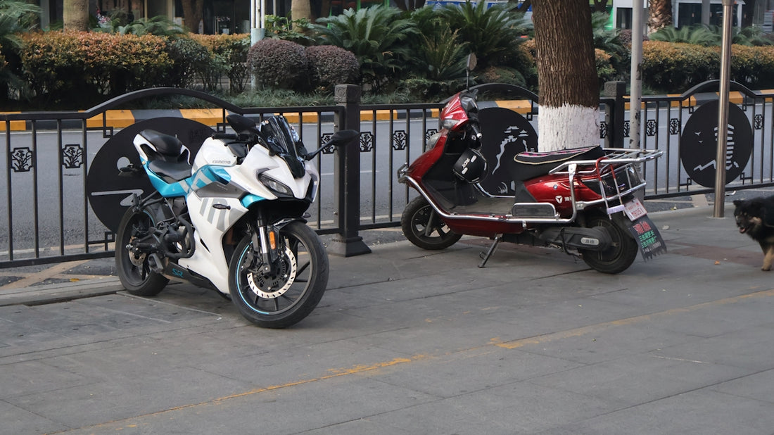 White and blue sportbike parked next to a red scooter.